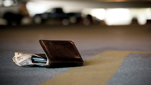 Wallet with cash left on ground of parking garage. Lost and found