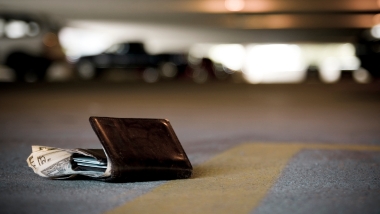 Brown wallet with cash lost on the ground of parking garage floor. Lost and Found