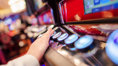 woman pushing slot machine button